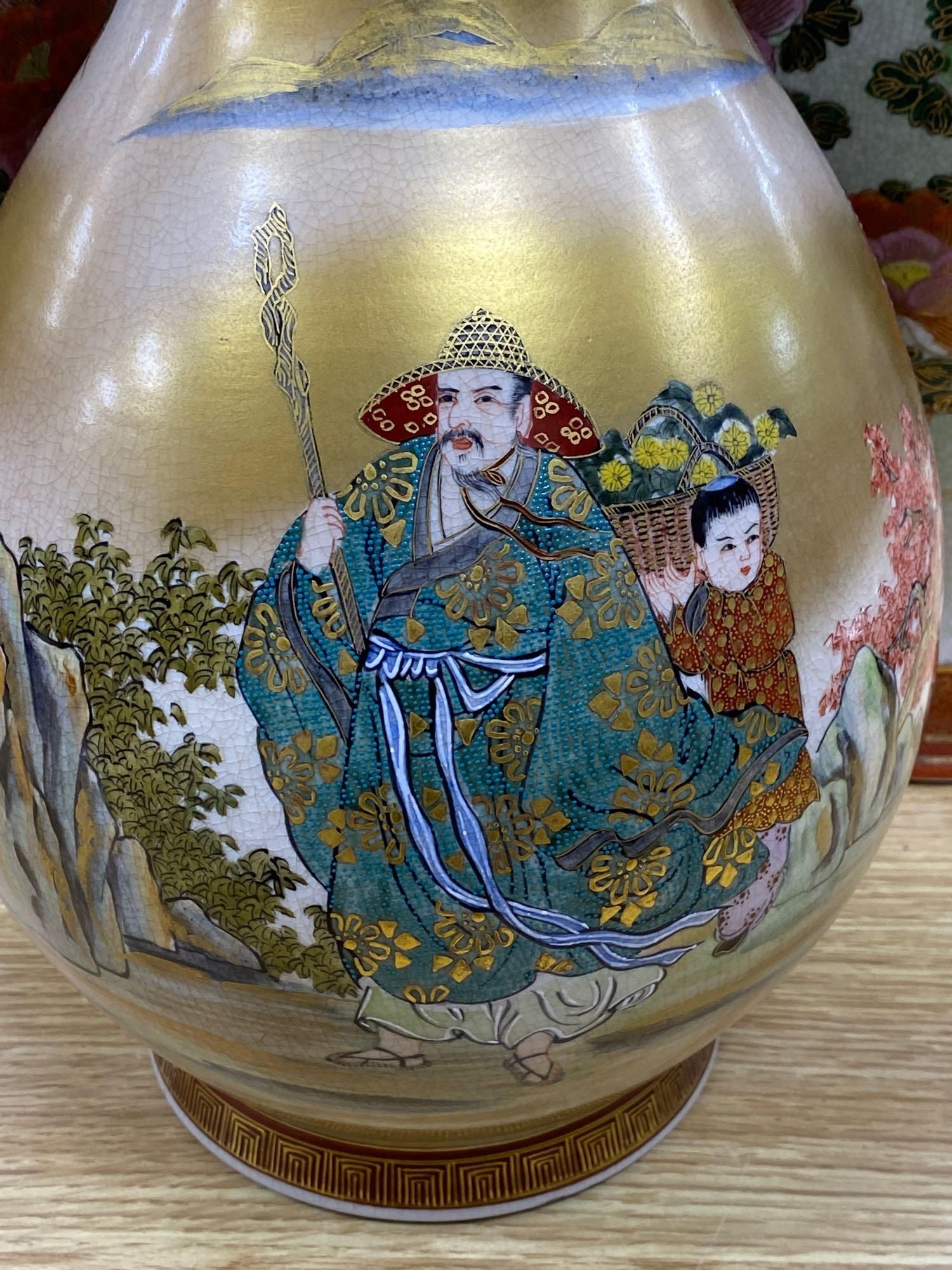 A pair of Japanese satsuma baluster vases, height 46cm, and a satsuma bulbous vase, height 37cm
